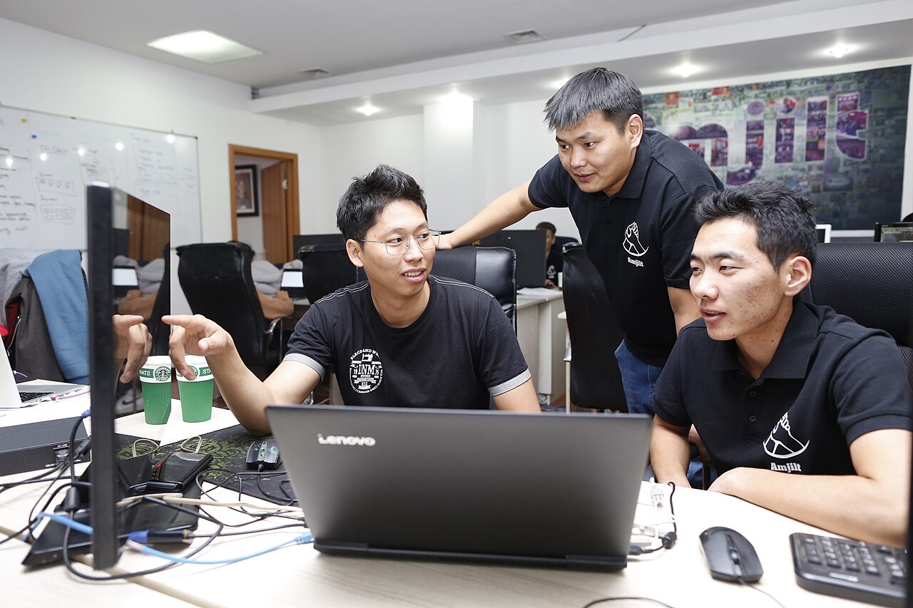Amjilt system团队围绕笔记本电脑协作的2019年资料照片